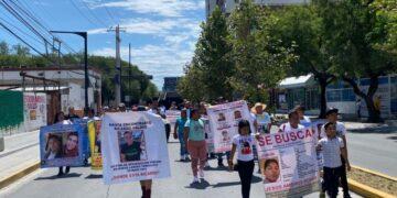 Crowd of Protesters Marching Down a Sunny City Street, Carrying Large Missing-person Posters Labeled 'se Busca' with Photos. - Salud Regia
