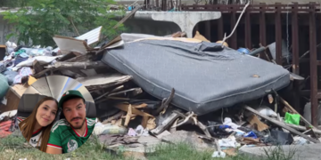 Trash and Debris Piled Beside a Metal Structure, with a Large Mattress; Circular Inset Shows a Couple Taking a Selfie in a Car - Salud Regia